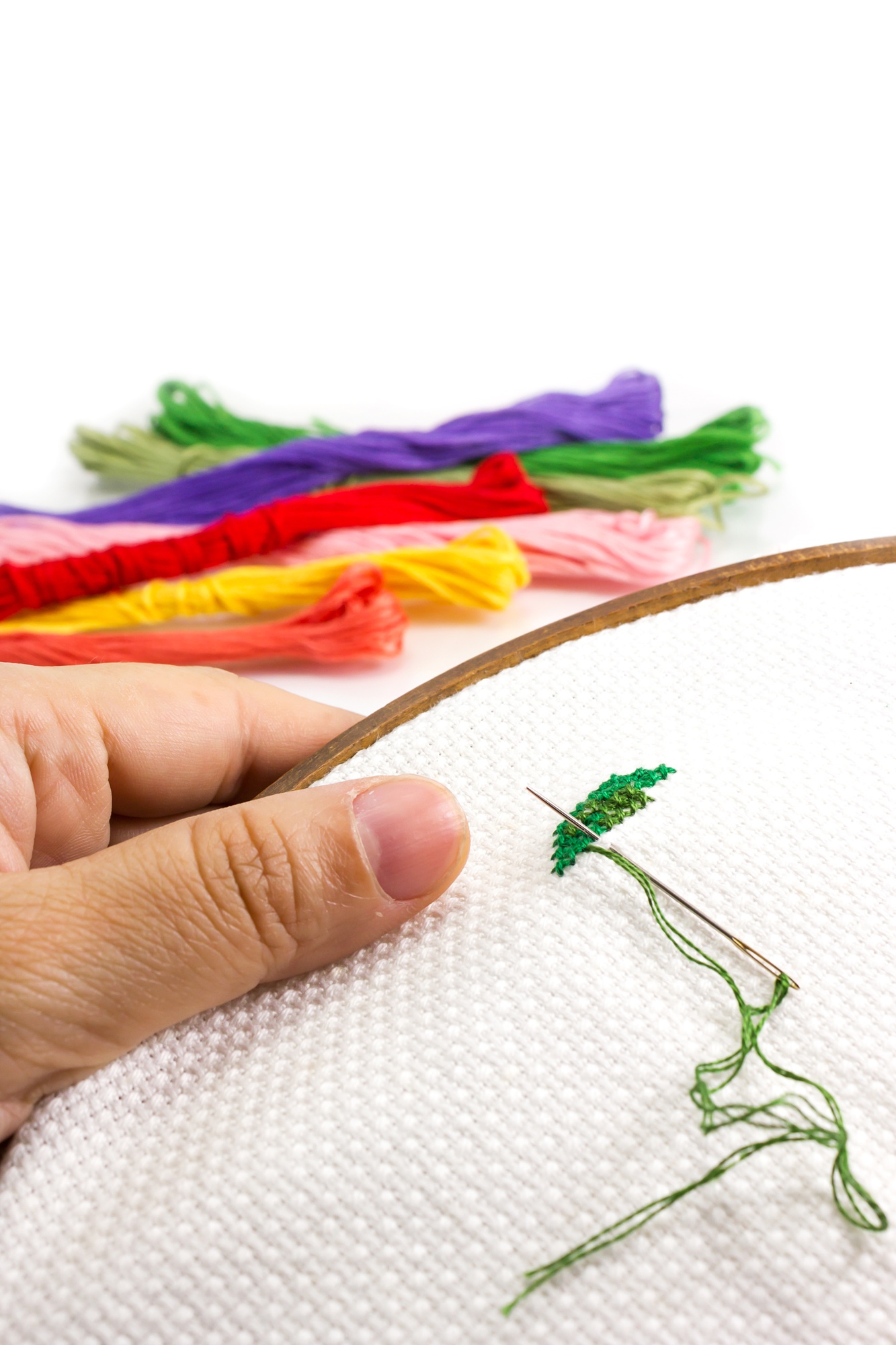 Artist hands embroidering detail